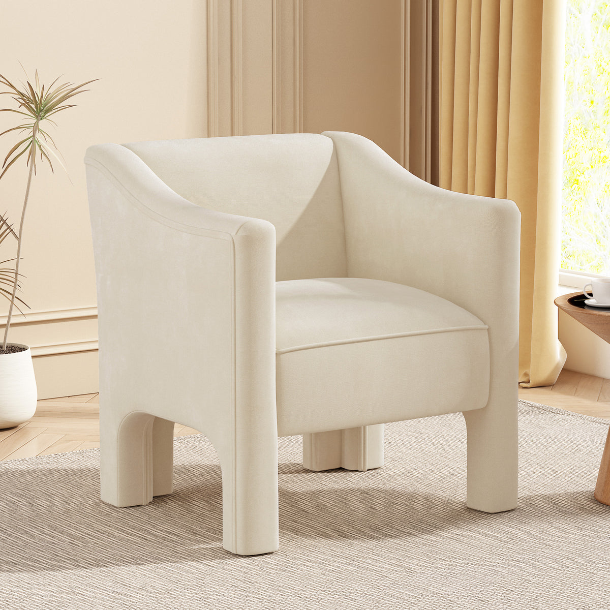 The Margot sculptural barrel chair in cream chenille, styled in a warm living room corner